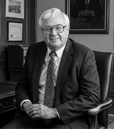 guy sitting in a professional looking office on a leather chair near a desk